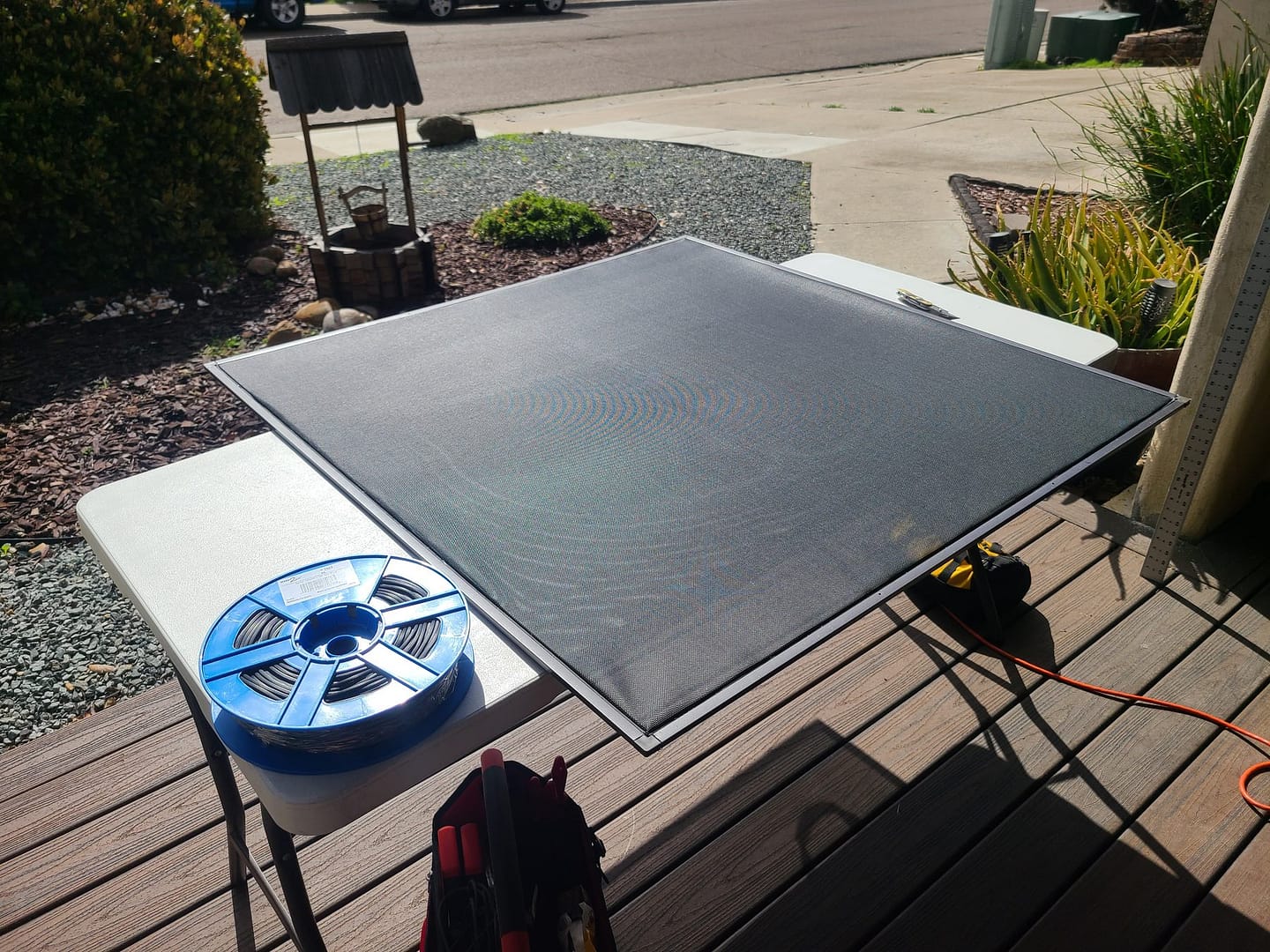 Window screen being re-screened with new mesh on site in San Diego