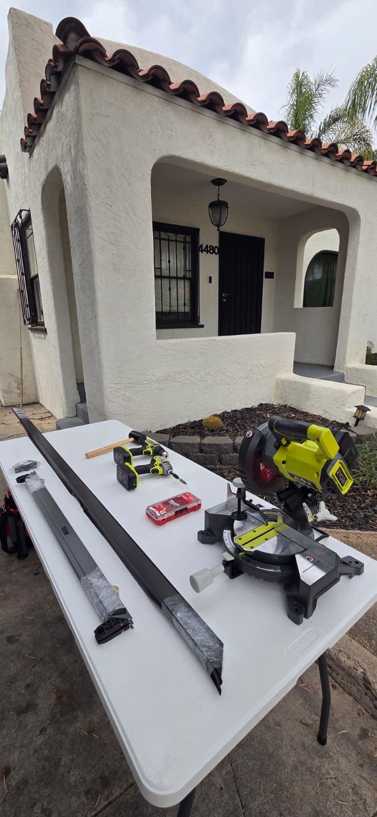 Custom sliding screen door frame laid out with tools before assembly